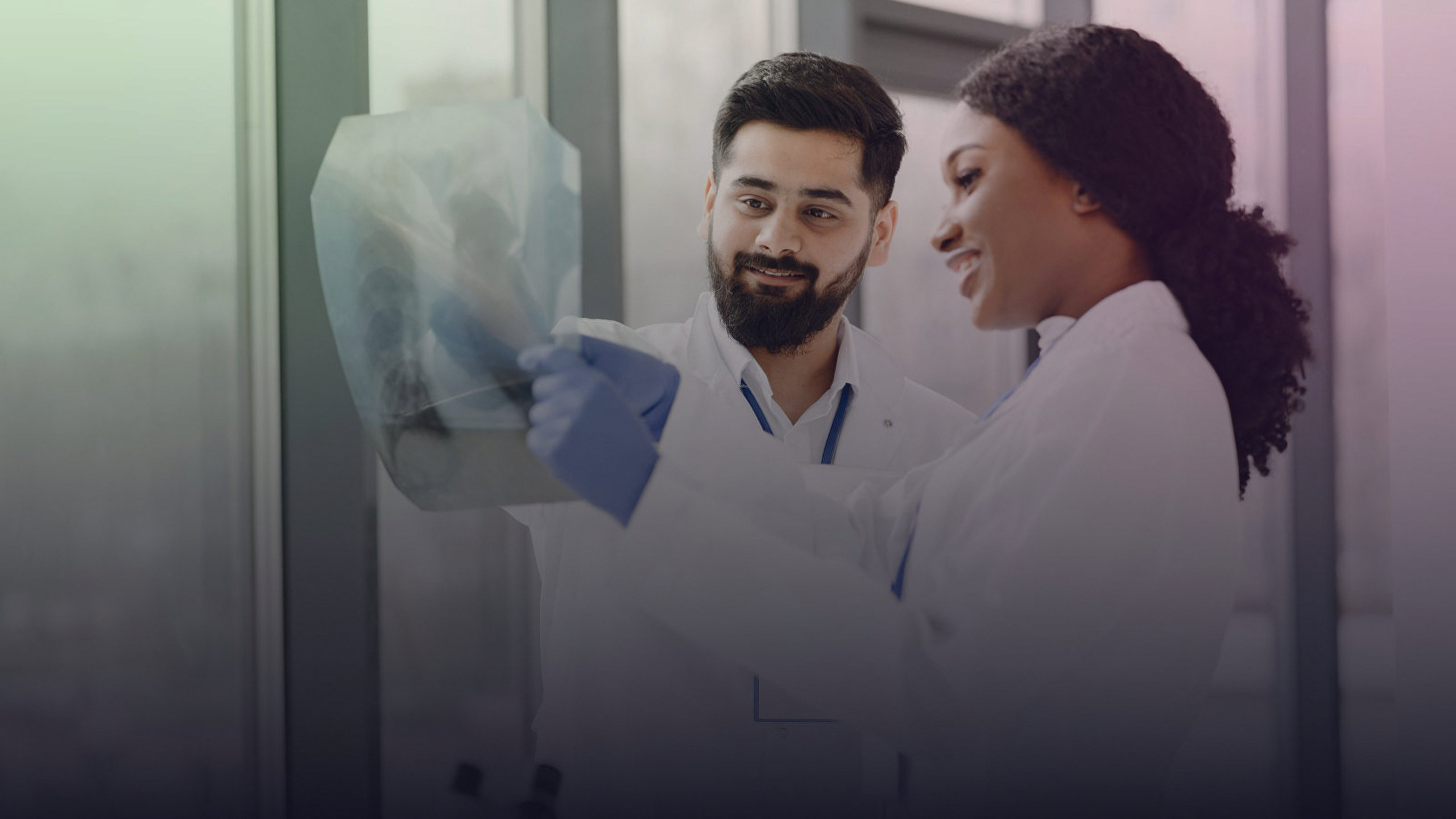 Two healthcare professionals examine an X-ray.