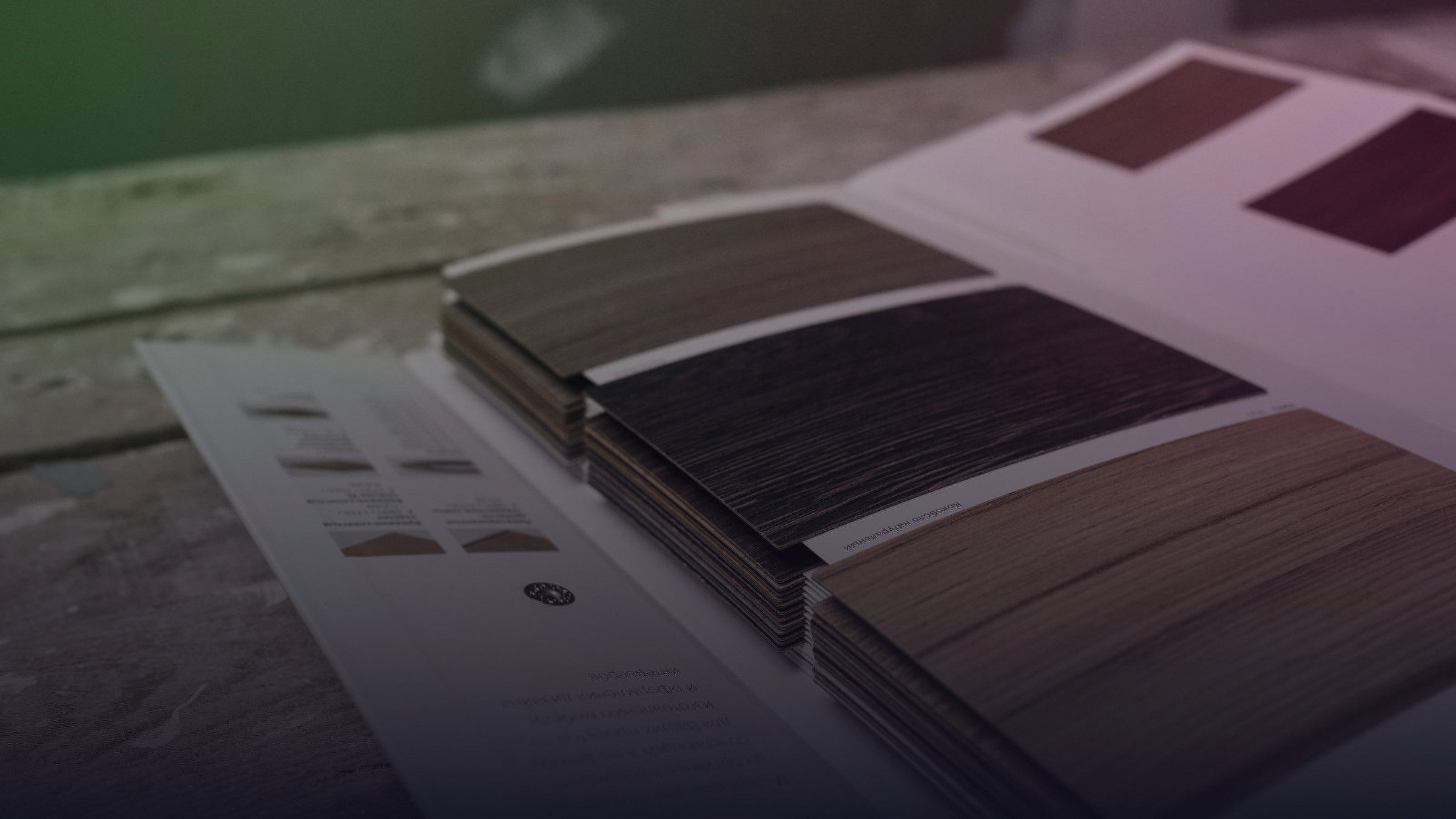 Wood material samples and color swatches lie on a table.