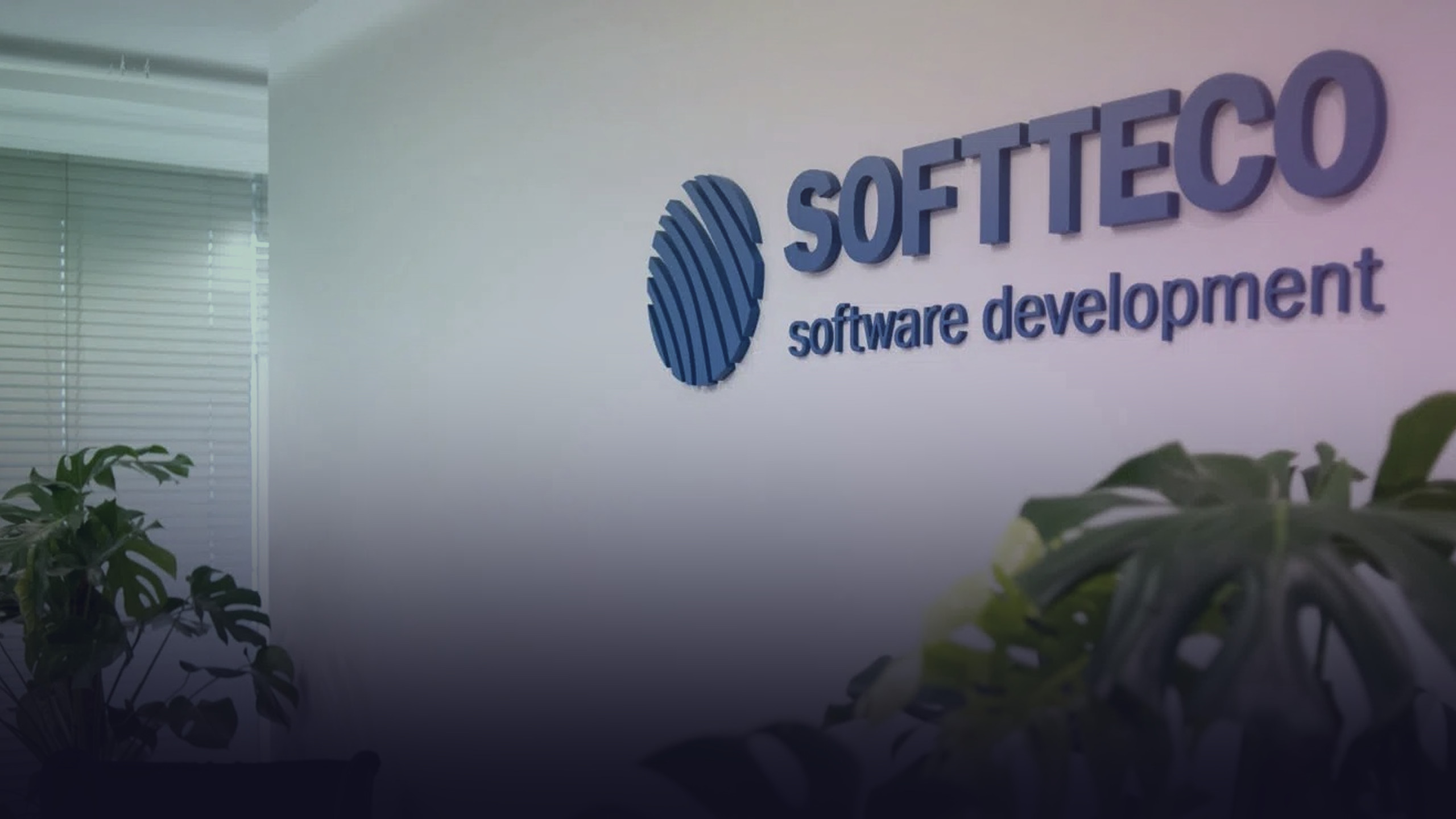 Softteco-Firmenschriftzug an einer Bürowand.